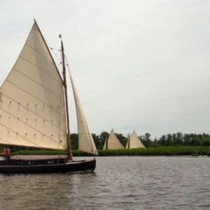 A wood class traditional wooden cabin yacht sailing a broad