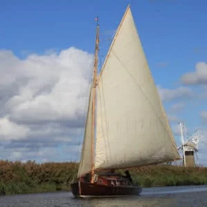 Luna, a Lullaby class traditional wooden cabin yacht sailing on the Norfolk Broads