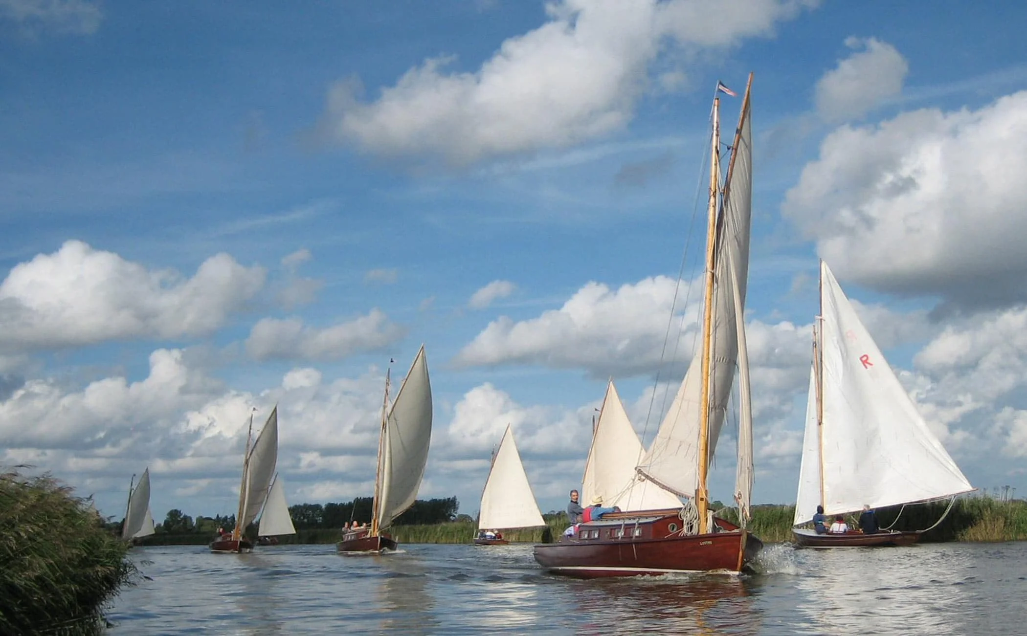 Fleet of traditional wooden Norfolk Broads sailing yachts